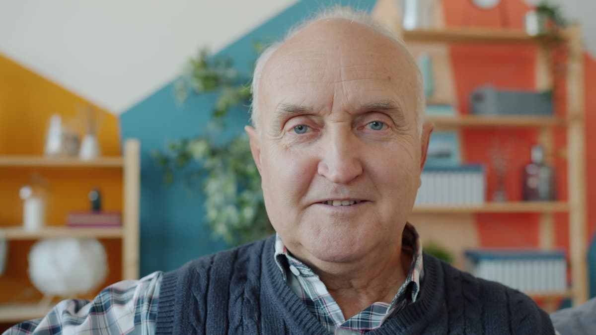 Elderly man with a warm smile at home